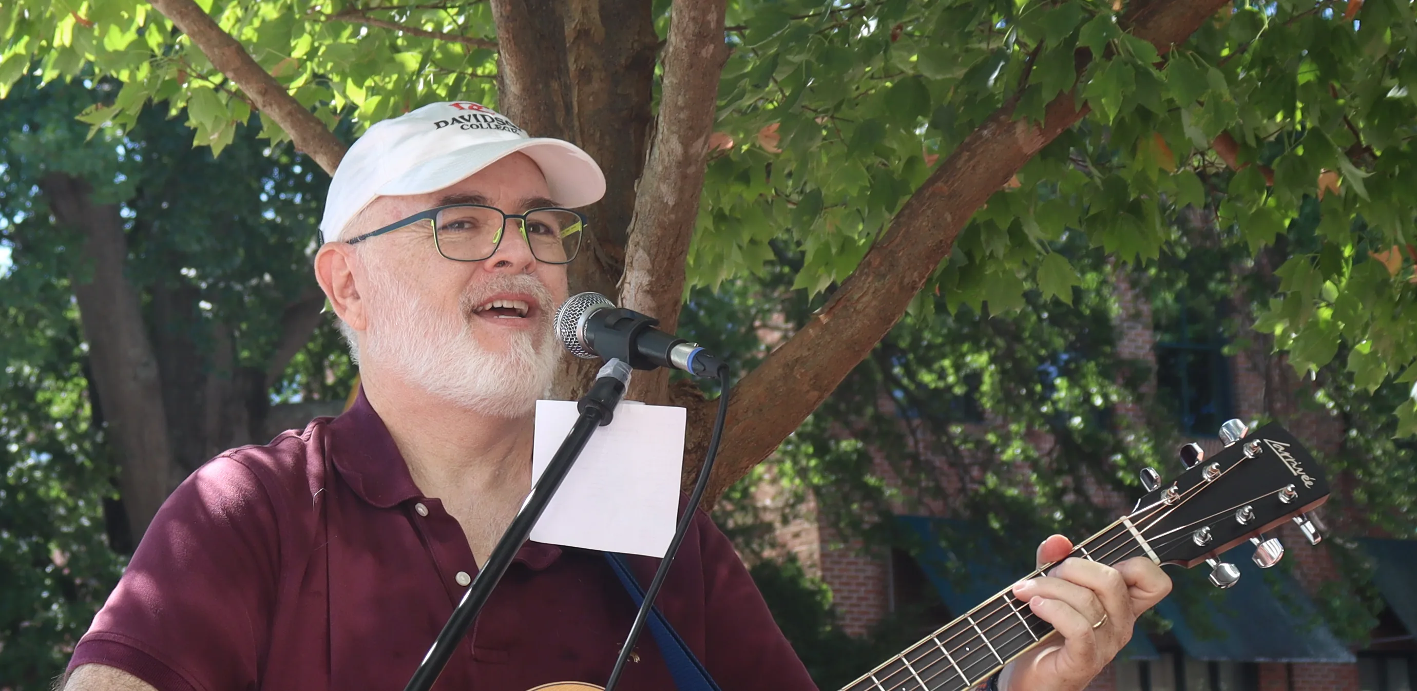 Bill Barnett performing outdoors with acoustic guitar